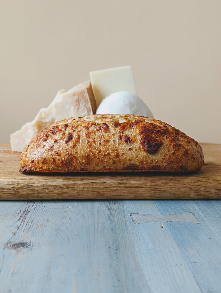 Sourdough 3-Cheese Loaf with Asiago, Mozzarella, and Parmesan on a wooden table