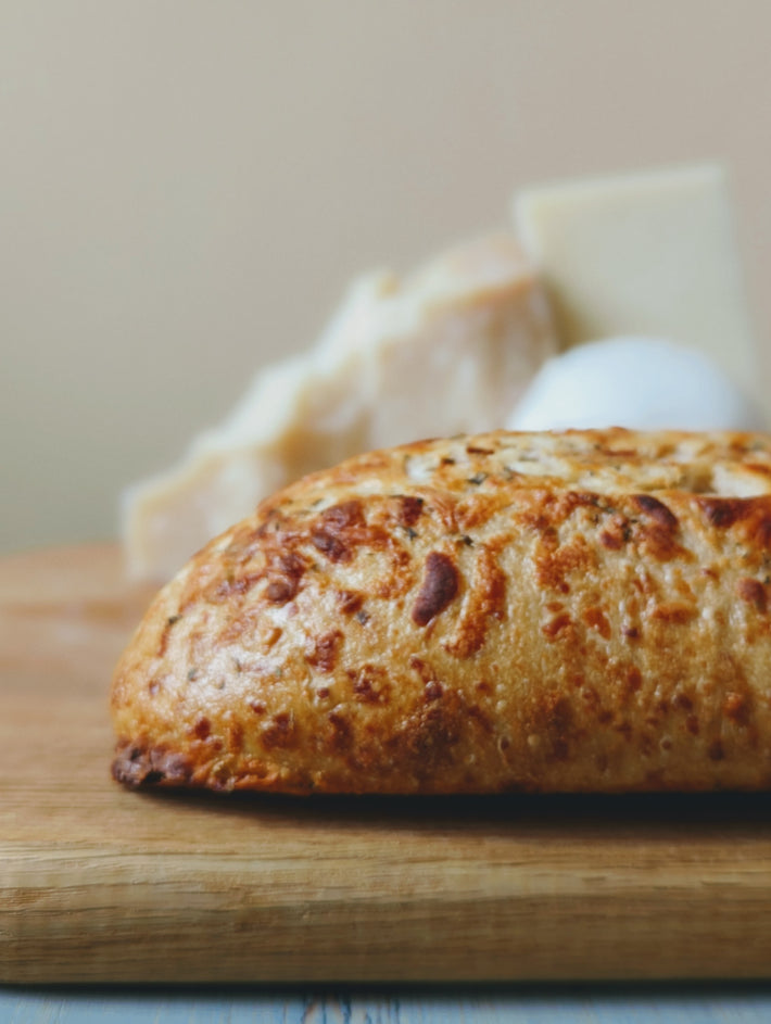 Sourdough 3-Cheese Loaf with a slice taken out, showcasing its crust and texture