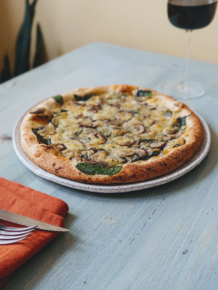 Slow-Fermented Veggie Pizza topped with mushrooms and spinach