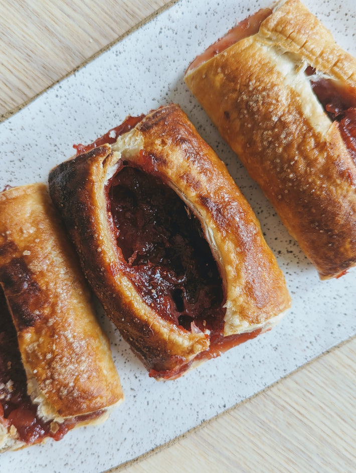 Strawberry Rhubarb Turnovers on a speckled white plate