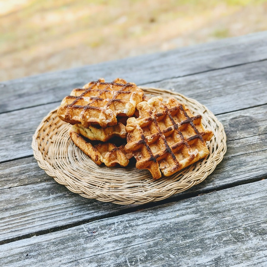 Artisanal Maple Belgian Waffles on a woven plate