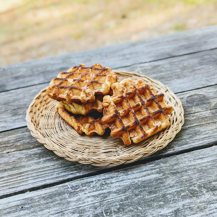 Artisanal Maple Belgian Waffles on a woven plate