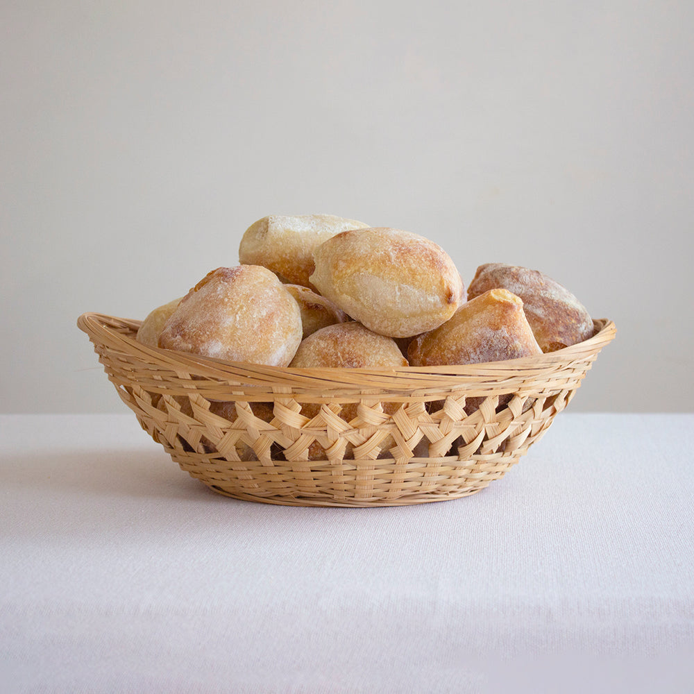 A basket filled with crusty sourdough rolls